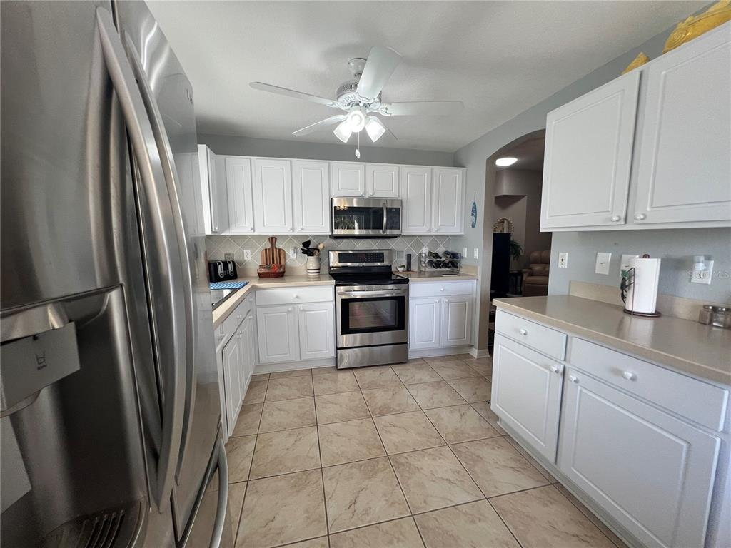 24472 Manchester Trail Punta Gorda, FL 33980 - Photo 19 of 46 a kitchen with white cabinets and white appliances