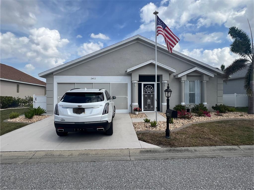 24472 Manchester Trail Punta Gorda, FL 33980 - Photo 2 of 46 a car parked in front of white house