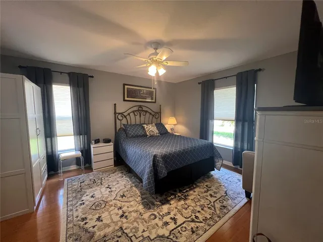 a bedroom with a bed lamps and a large mirror