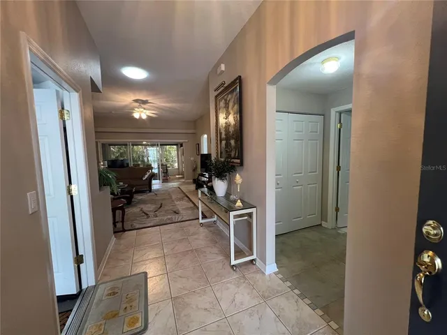 a view of a hallway with living room and furniture
