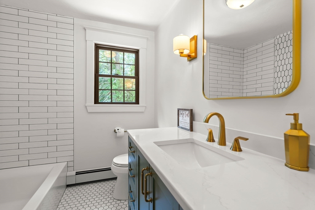 38 Manchaug Road Sutton, MA 01590 - Photo 28 of 40 a bathroom with a sink and a bathtub