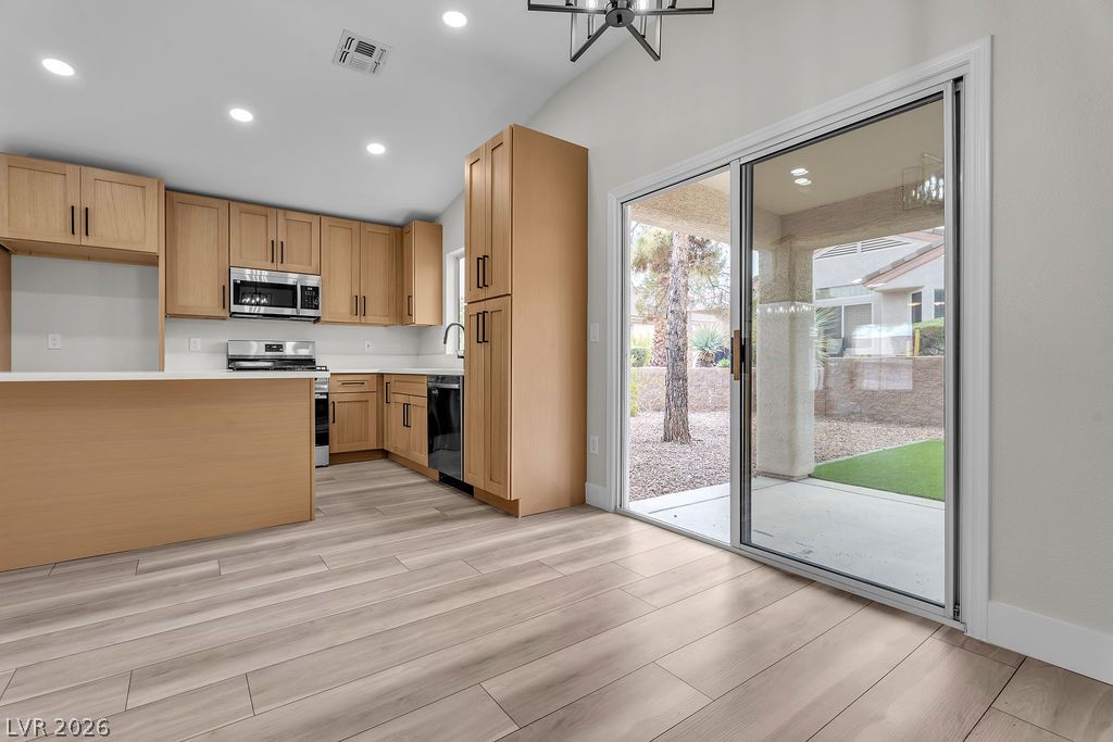 2139 Chapman Ranch Drive Henderson, NV 89012 - Photo 22 of 58 A well-appointed kitchen features ample cabinetry, modern appliances, and convenient access to the outdoor living space.