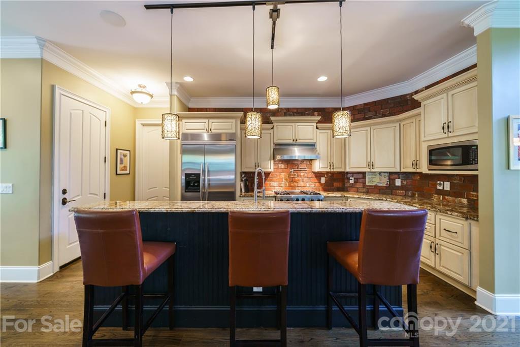 17405 Sail View Drive Cornelius, NC 28031 - Photo 11 of 43 a kitchen with stainless steel appliances granite countertop a table chairs sink refrigerator and microwave