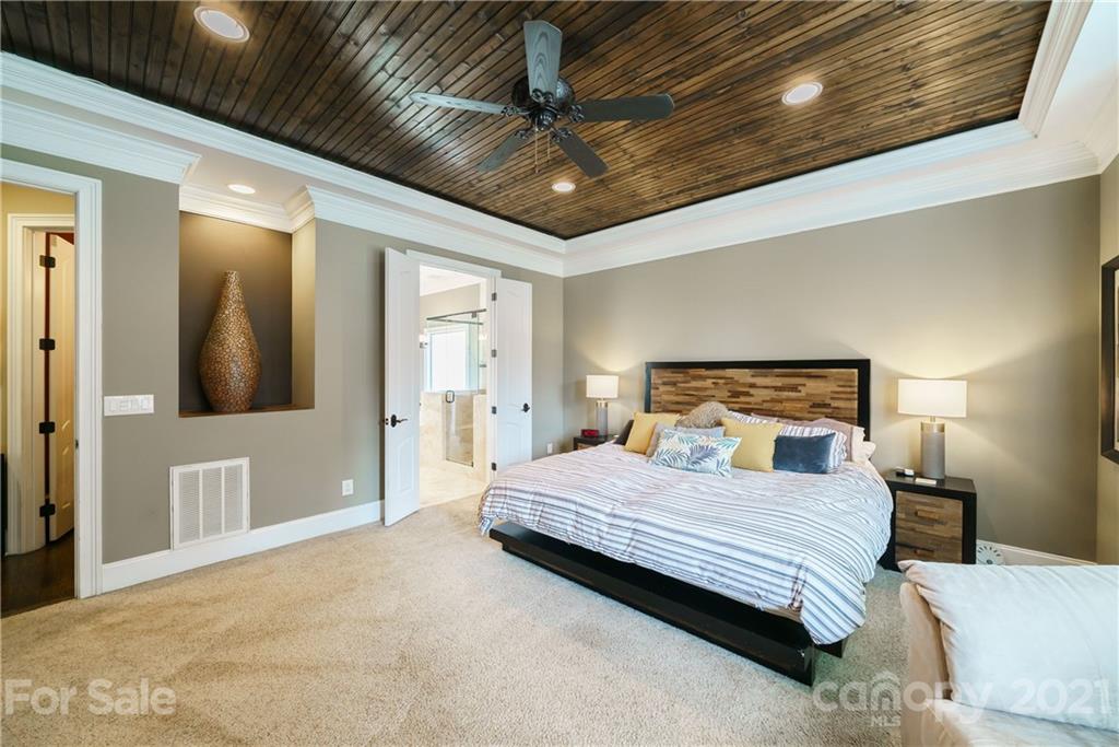 17405 Sail View Drive Cornelius, NC 28031 - Photo 16 of 43 a bedroom with a large bed and a chandelier