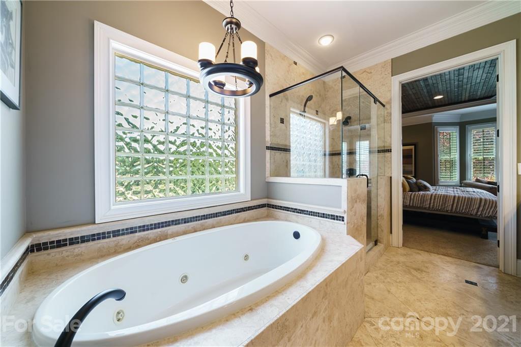 17405 Sail View Drive Cornelius, NC 28031 - Photo 20 of 43 a bathroom with a tub a sink and a large window