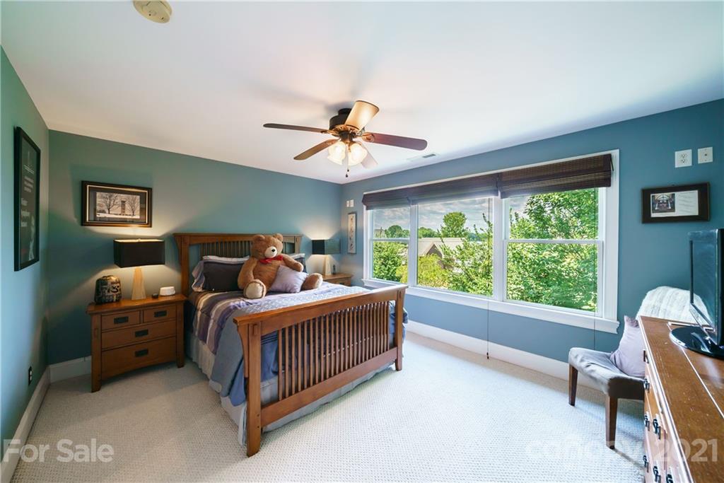 17405 Sail View Drive Cornelius, NC 28031 - Photo 22 of 43 a bed room with a bed and a chandelier