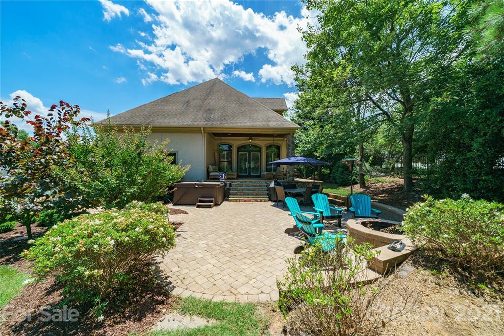 17405 Sail View Drive Cornelius, NC 28031 - Photo 28 of 43 a view of a patio with table and chairs potted plants and large tree