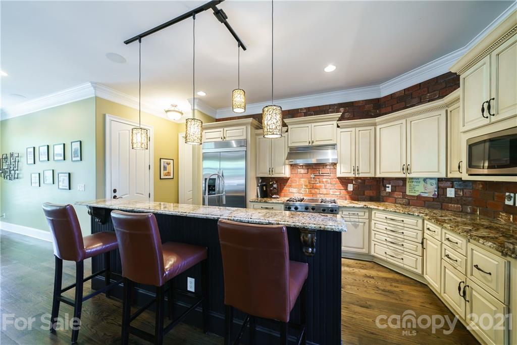 17405 Sail View Drive Cornelius, NC 28031 - Photo 6 of 43 a kitchen with stainless steel appliances granite countertop a sink a stove a dining table and chairs