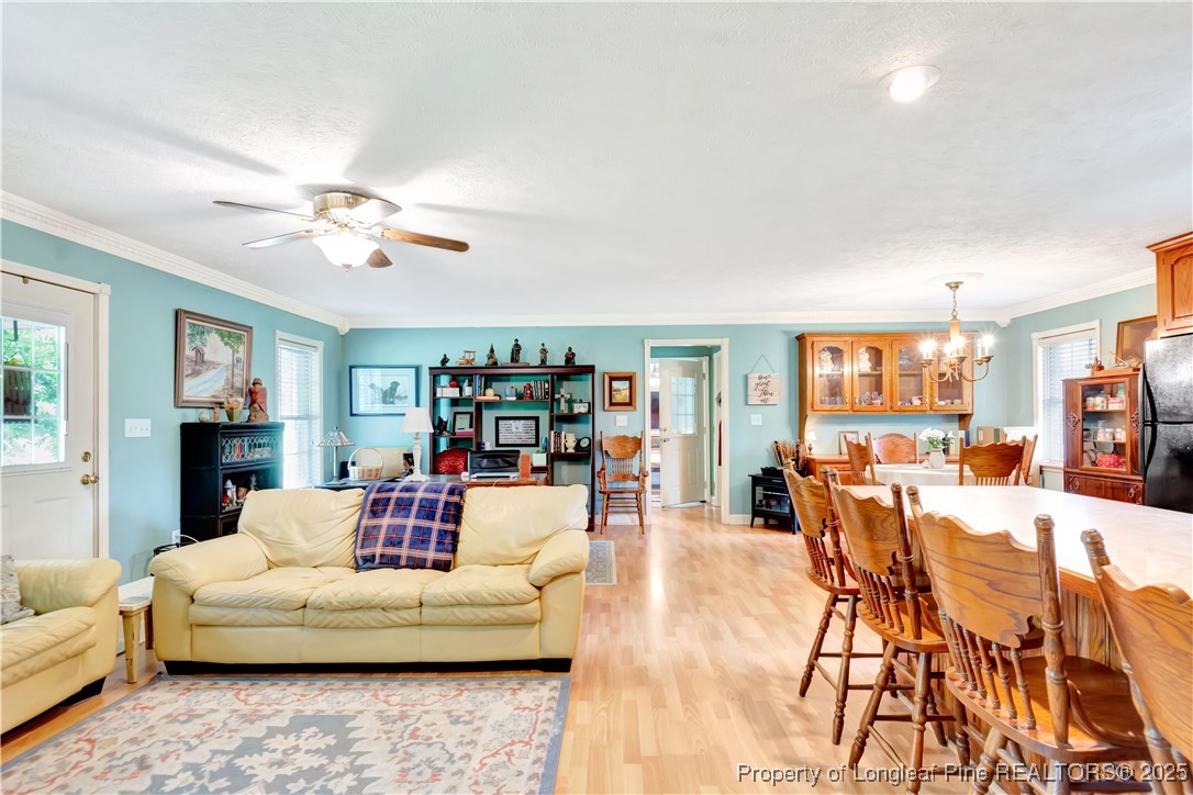 1079 Charlie Williamson Road Whiteville, NC 28472 - Photo 11 of 35 a living room with furniture and a wooden floor