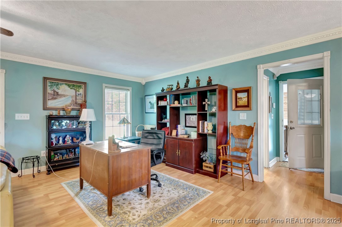 1079 Charlie Williamson Road Whiteville, NC 28472 - Photo 12 of 35 a living room with furniture and a book shelf