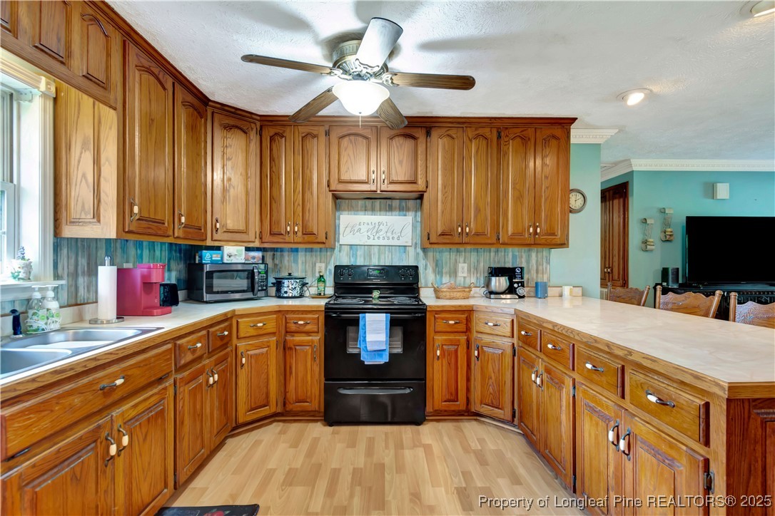1079 Charlie Williamson Road Whiteville, NC 28472 - Photo 13 of 35 a kitchen with stainless steel appliances granite countertop a stove sink and cabinets