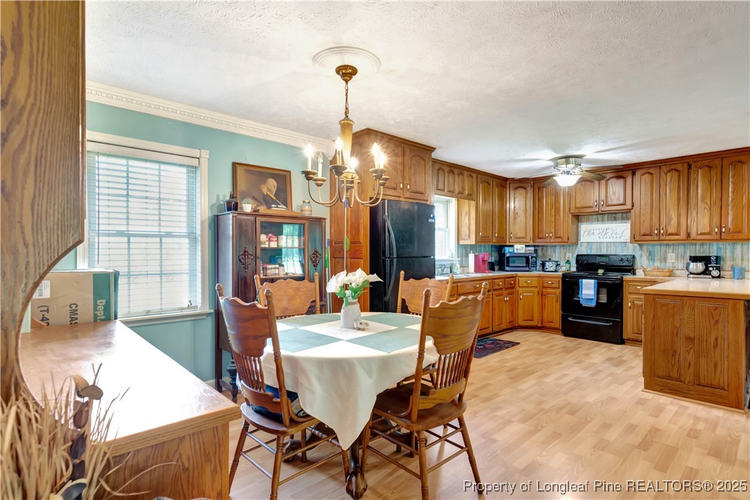 1079 Charlie Williamson Road Whiteville, NC 28472 - Photo 16 of 35 a dining room with furniture a window and kitchen view