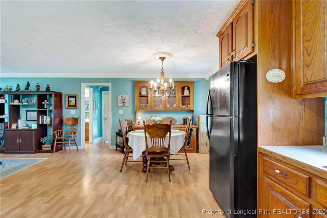 1079 Charlie Williamson Road Whiteville, NC 28472 - Photo 17 of 35 a view of a dining room with furniture and wooden floor
