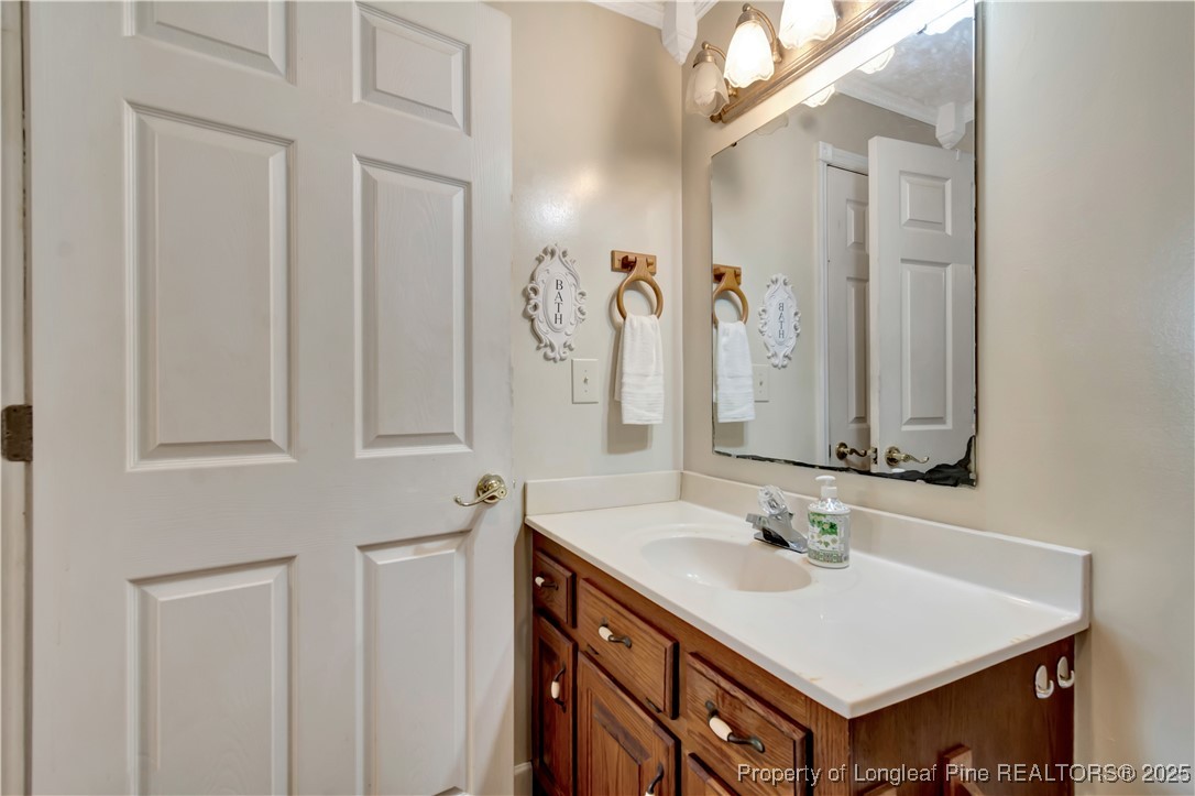 1079 Charlie Williamson Road Whiteville, NC 28472 - Photo 23 of 35 a bathroom with a sink and a mirror
