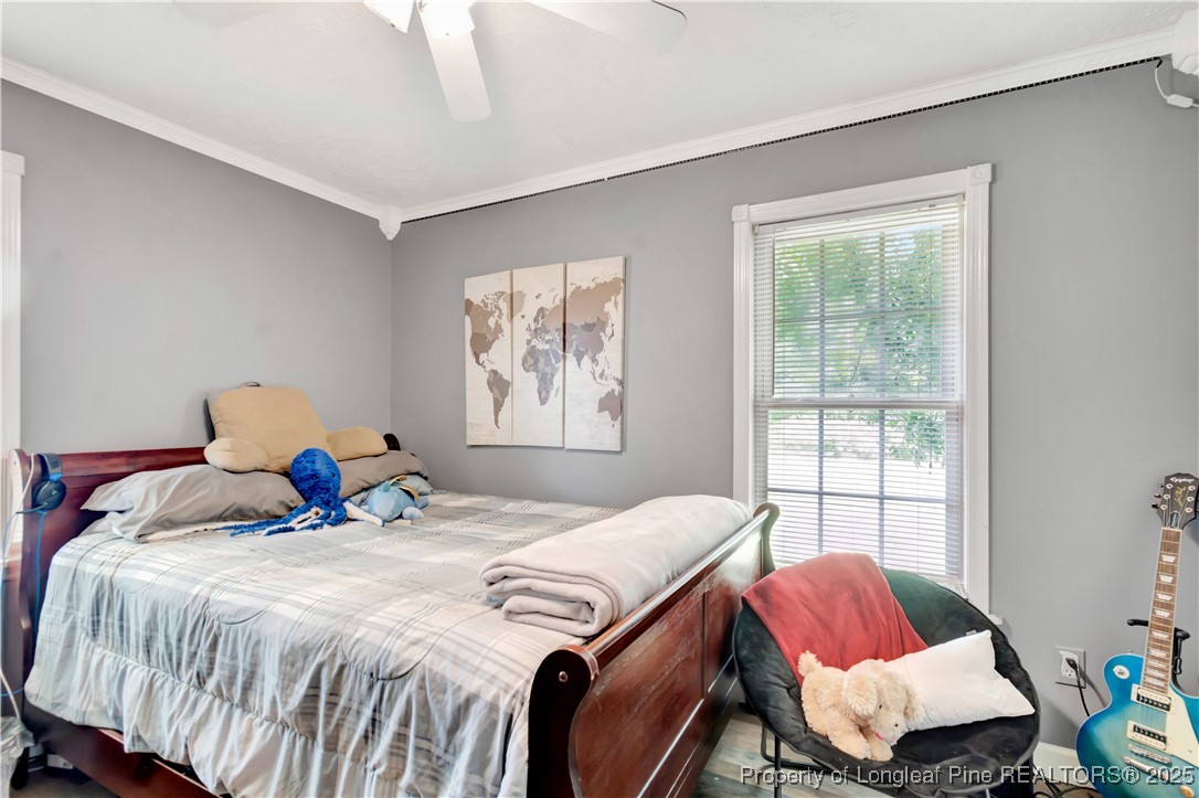 1079 Charlie Williamson Road Whiteville, NC 28472 - Photo 24 of 35 a bedroom with a bed and wooden floor