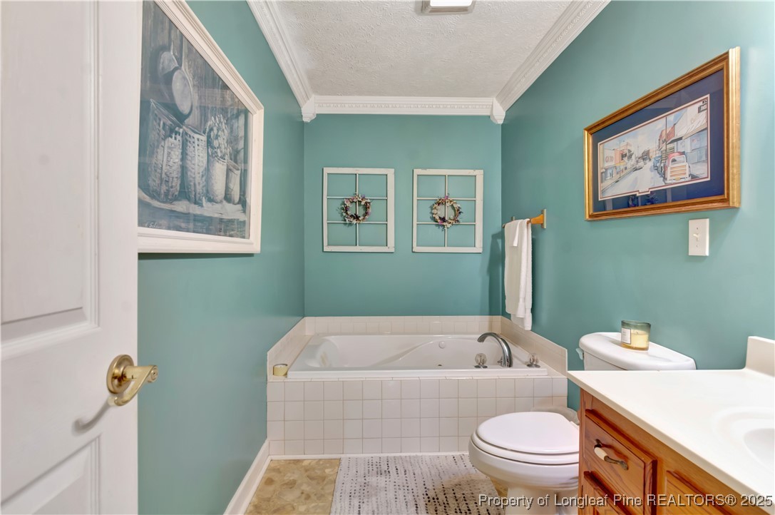 1079 Charlie Williamson Road Whiteville, NC 28472 - Photo 27 of 35 a bathroom with a bathtub and toilet