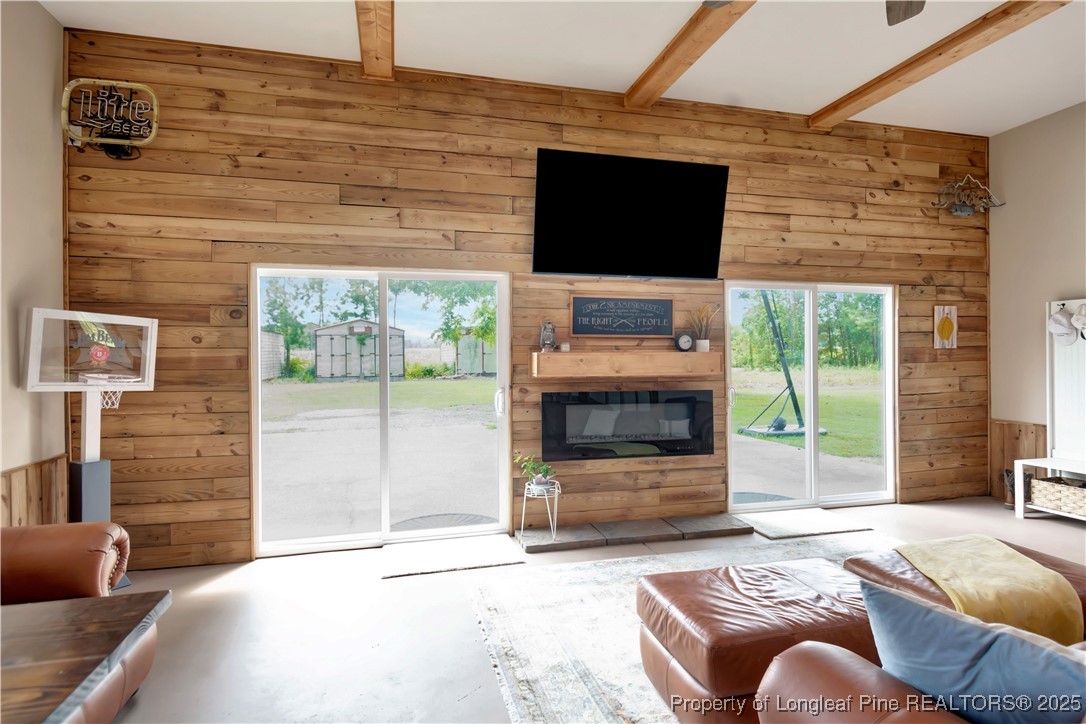 1079 Charlie Williamson Road Whiteville, NC 28472 - Photo 30 of 35 a living room with furniture a flat screen tv and a fireplace
