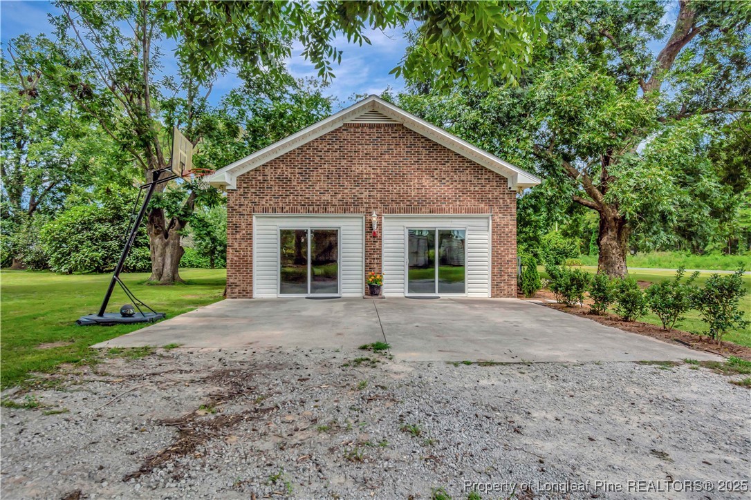 1079 Charlie Williamson Road Whiteville, NC 28472 - Photo 34 of 35 a view of a house with backyard and trees