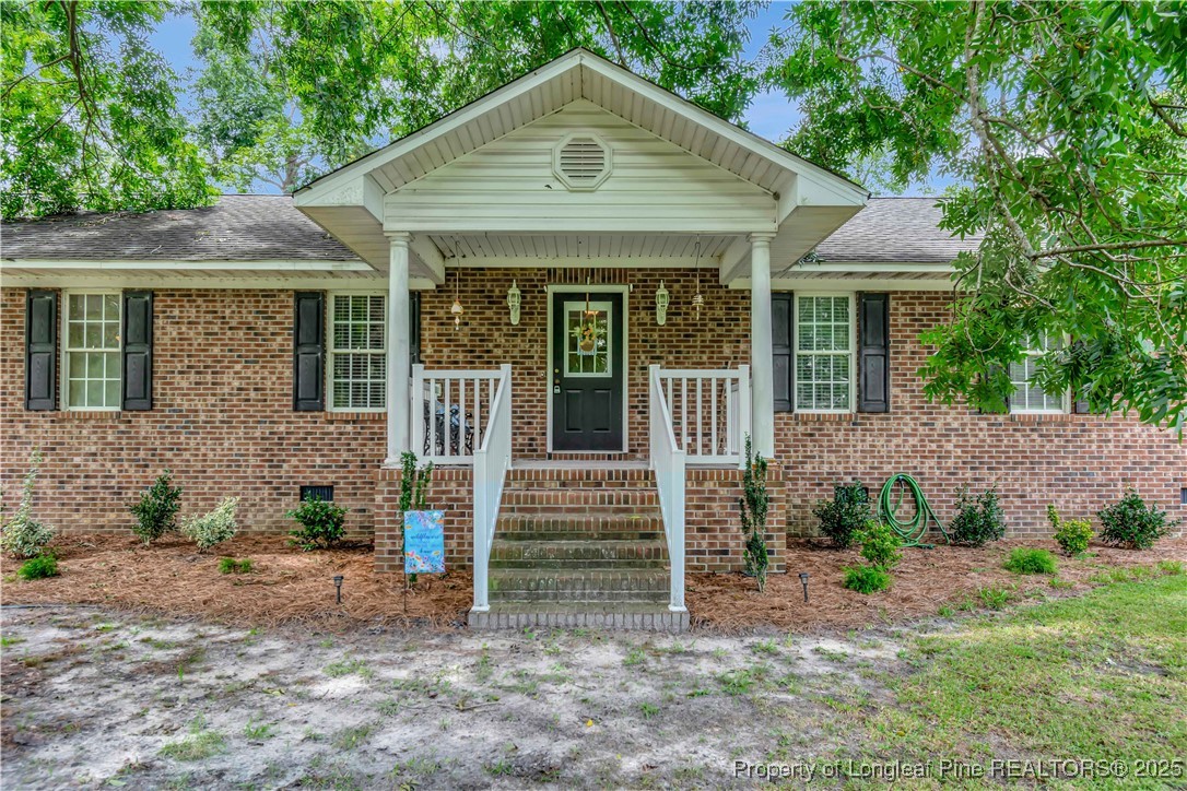 1079 Charlie Williamson Road Whiteville, NC 28472 - Photo 5 of 35 a front view of a house with garden