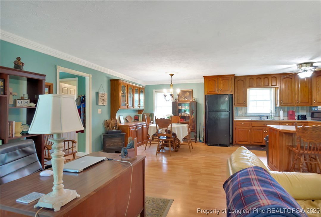 1079 Charlie Williamson Road Whiteville, NC 28472 - Photo 7 of 35 a living room with furniture a dining table and a refrigerator