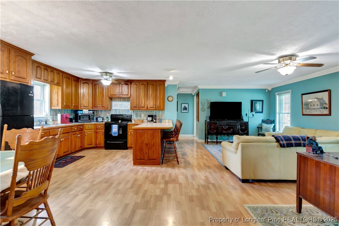 1079 Charlie Williamson Road Whiteville, NC 28472 - Photo 8 of 35 a living room with furniture kitchen and a flat screen tv