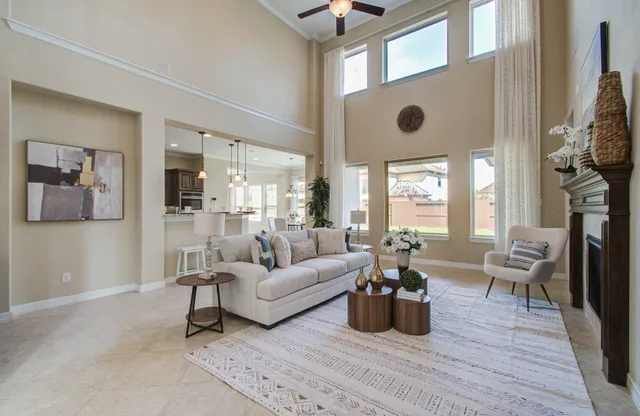 a living room with furniture wooden floor and a large window