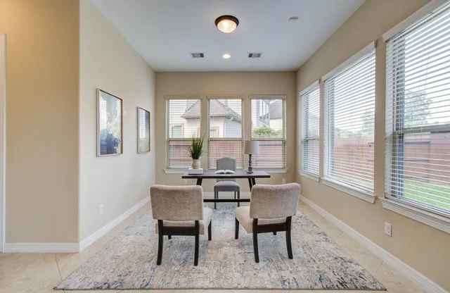 a view of a dining room with furniture window and outside view