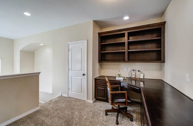 a view of a workspace with furniture