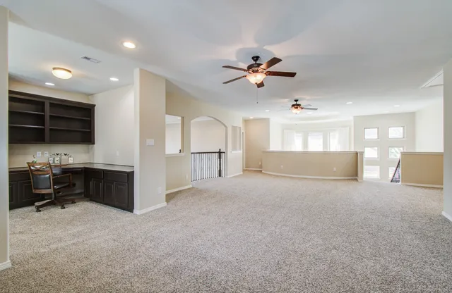 a view of a livingroom with furniture and a kitchen