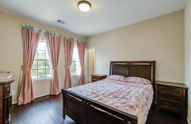 a bed sitting in a bedroom next to a window