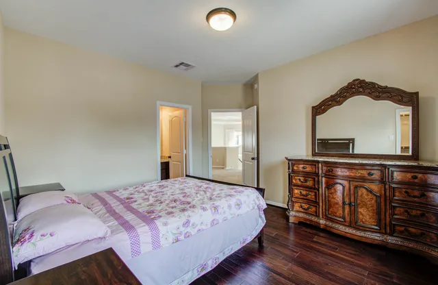 a bedroom with a bed and a dresser