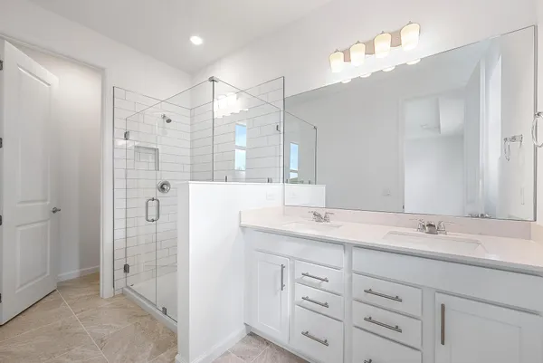 a bathroom with a shower sink double and mirror