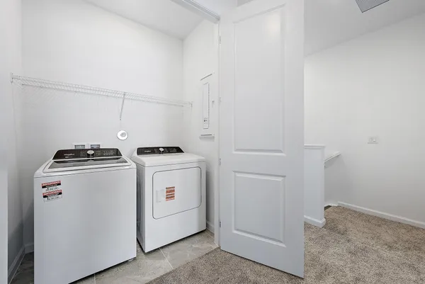 a view of storage and utility room with washer and dryer