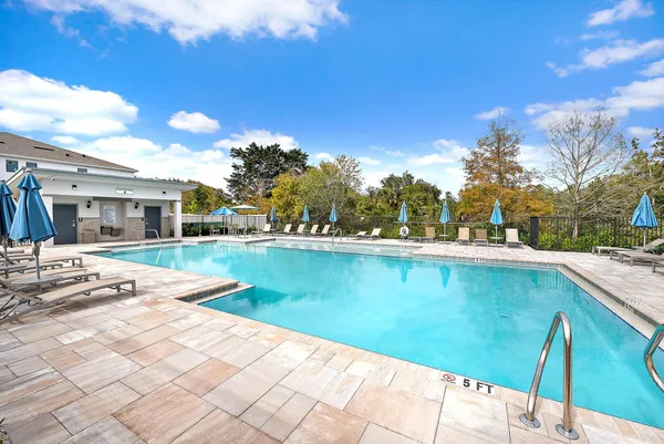 a view of swimming pool with outdoor seating and yard