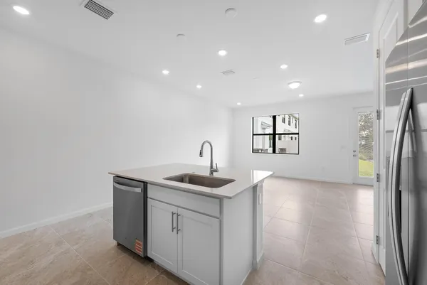 a kitchen with a sink and refrigerator
