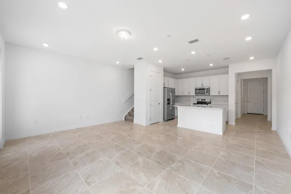 a view of kitchen with kitchen island a sink a center island stainless steel appliances and a cabinets