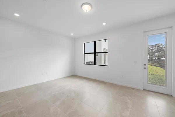 an empty room with windows and closet