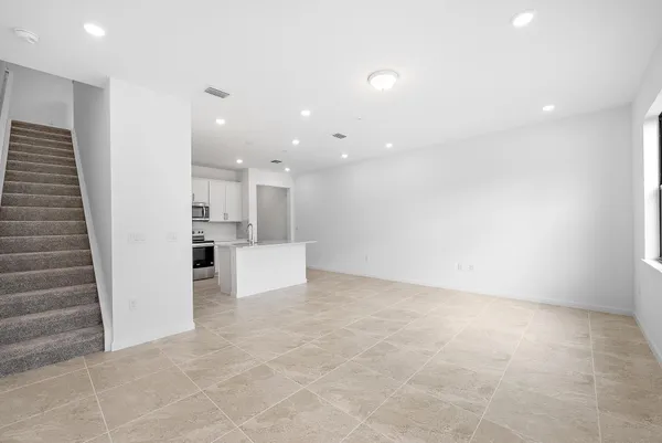 a view of a kitchen with a sink and cabinets