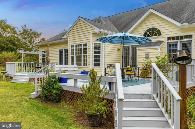 a front view of a house with a yard table and chairs