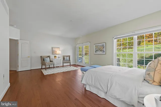 a bed room with a bed and a chair