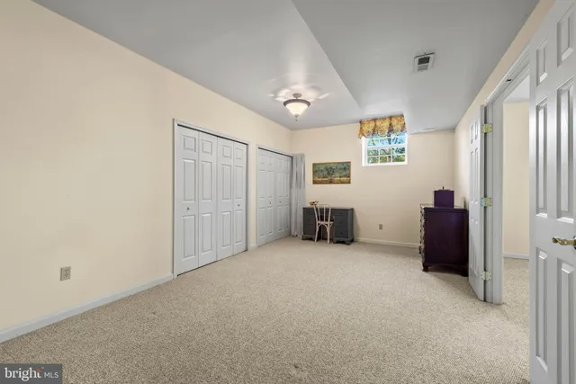 a view of a livingroom with entryway and bedroom view