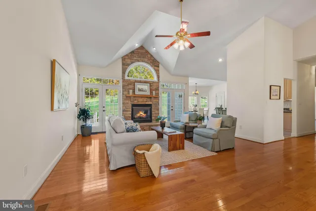 a living room with fireplace furniture and a large window