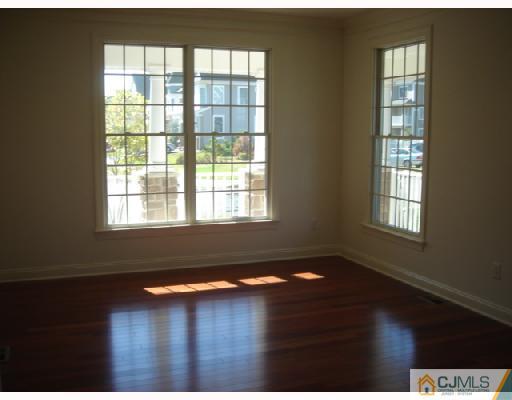 74 Raritan Reach Road South Amboy, NJ 08879 - Photo 7 of 8 a view of an empty room with wooden floor and a window