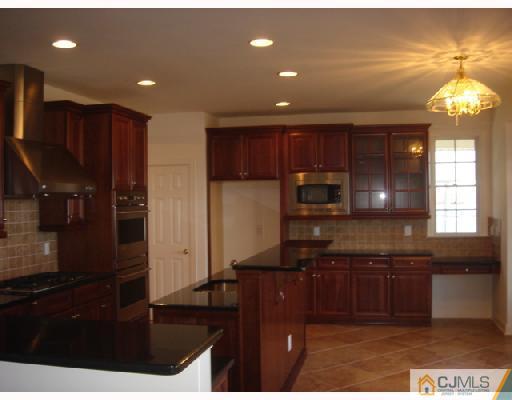 74 Raritan Reach Road South Amboy, NJ 08879 - Photo 8 of 8 a kitchen with kitchen island granite countertop stainless steel appliances a sink stove and refrigerator
