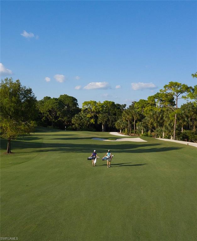 1820 Pondside Lane Naples, FL 34109 - Photo 17 of 17 a view of a golf course with a lake
