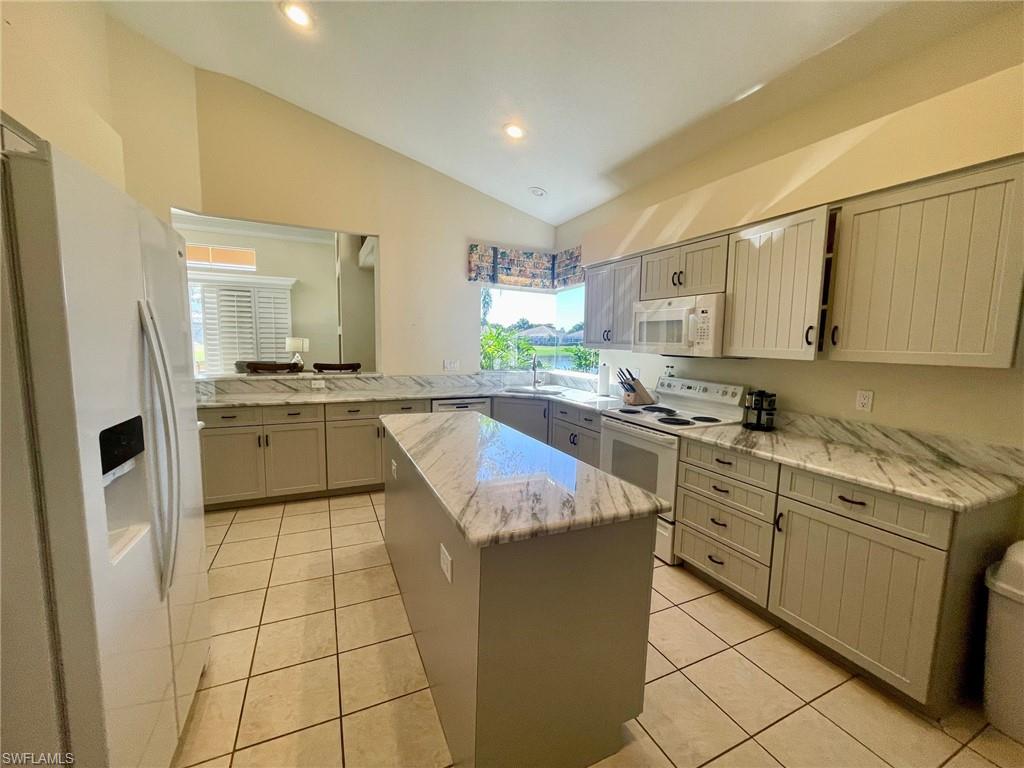 1820 Pondside Lane Naples, FL 34109 - Photo 5 of 17 a kitchen with stainless steel appliances granite countertop a sink stove and refrigerator