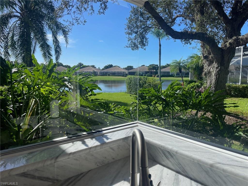 1820 Pondside Lane Naples, FL 34109 - Photo 6 of 17 a view of a balcony with a tree