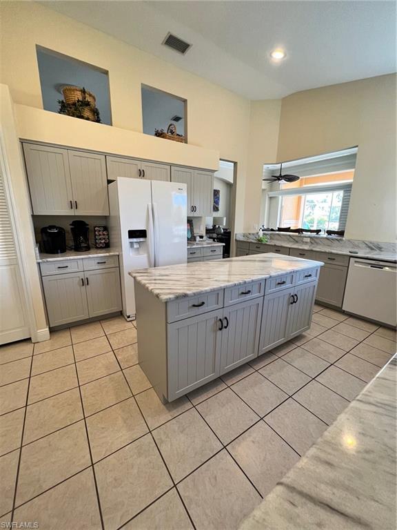 1820 Pondside Lane Naples, FL 34109 - Photo 7 of 17 a kitchen with a sink a stove top oven and cabinets