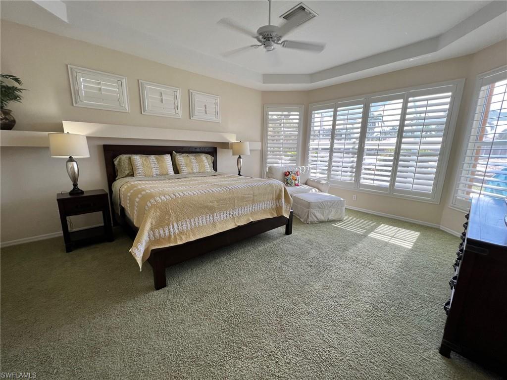 1820 Pondside Lane Naples, FL 34109 - Photo 8 of 17 a spacious bedroom with a bed and a couch