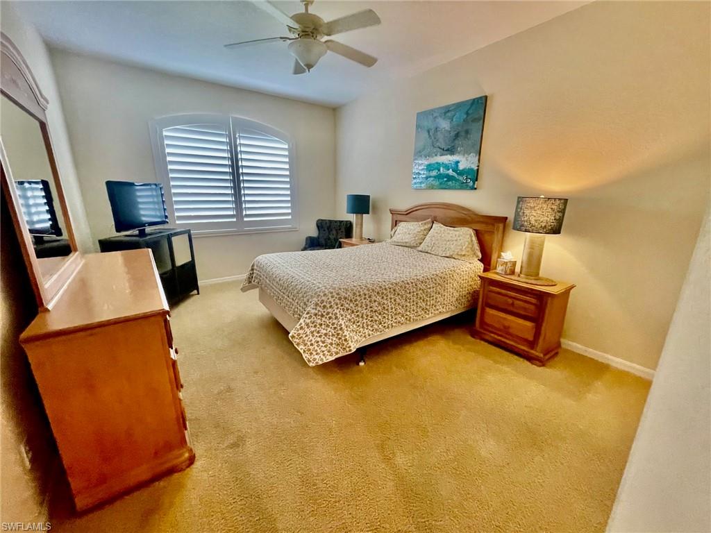 1820 Pondside Lane Naples, FL 34109 - Photo 10 of 17 a bedroom with a bed and wooden floor